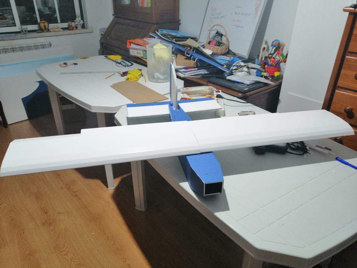 A fixed-wing UAV under construction on a table